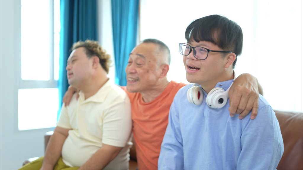 A family with an autistic child enjoys singing and dancing together at home during the holidays